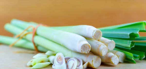 Fresh lemongrass rope and lemongrass slice on wooden cutting board in cooking concept.